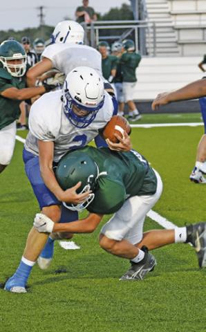 SNOOK’S KADE JUNEK carries the ball against Normangee in the scrimmage.