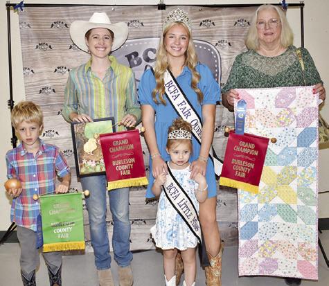 RORY CHATWIN WON grand champion for produce, Ivy Chatwin for adult watercolor, collage, unusual farm product, garden produce, shrubbery and landscape, insect and fire art floral photography. Ruth Albright won grand champion for miscellaneous quilting. Also pictured are Burleson County Fair Queen Hadleigh Novosad and Burleson County Fair Little Miss Avery Grace Freeman.