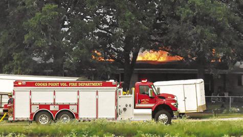 COOKS POINT VOLUNTEER firefighters respond to the scene of this house fire on July 16 on F.M. 1362 South. Tribune photo by Roy Sanders