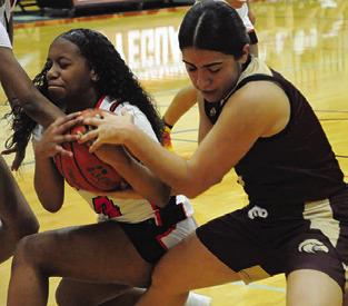 KAMRYN HARRIS wins this battle for possession against a Milano player during Friday’s game. Tribune photo by Denise Squier