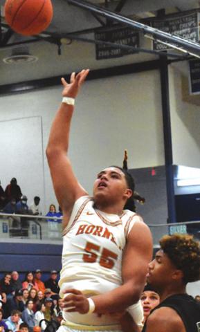 CALDWELL’S DELVIN Morris shoots the ball while Franklin’s Devyn Hidrogo looks on.