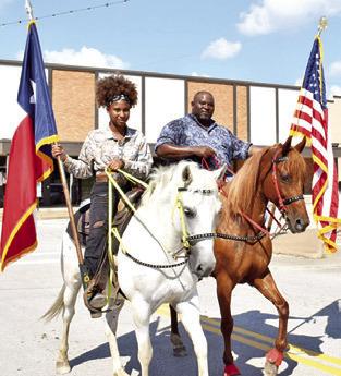 ROGER RICHMOND and his daughter Rachel Richmond carry the flags on Saturday at the annual Juneteenth Parade in Caldwell.