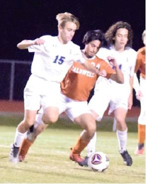 CALDWELL’S CHRIS AMAYA battles with a player from Manor New Tech for possession of the ball. -- Tribune photo by Denise Hornaday