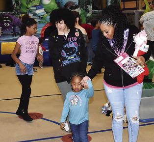 CHILDREN ENJOY THE toy walk on Saturday at the Santaville celebration at the Yegua Center in Somerville.