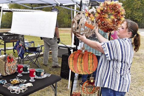 ANGIE CARPENTER OF Angie’s Assortments arranges these displays on Saturday, Nov. 15, at the Yellow Prairie Market in Chriesman.