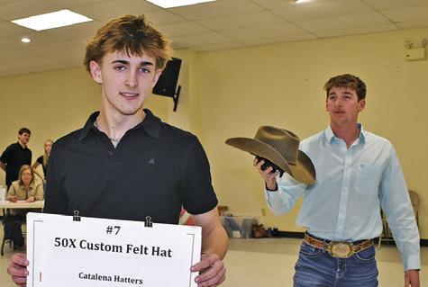 DYLAN CHAPMAN AND Colby Maresh display these items on Saturday night at the annual Go Texan Auction.