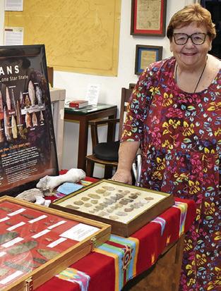 MELYNDA GIESENSCHLAG looks over these items at the Burleson County Museum in the courthouse. Burleson County will celebrate Heritage Week on March 23-28.