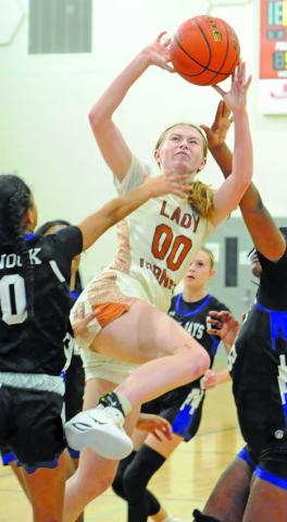 IRELAND MORGAN is fouled by Jai’Nylah Curry during the Caldwell-Snook game last Thursday. Also pictured is Jaci’lee Perez. Tribune photo by Denise Squier