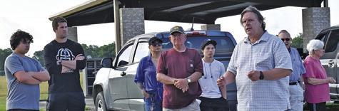 CHARLES HULME, AN Oaklawn Cemetery board member, addressing the gathering on Saturday during the cleanup effort. Also pictured are, from left, student Hunter Tuck, Athletic Director Luke Klingler, Rose Vaiz, Mr. Machemehl, Andrew Vaiz, and Carl and Ruth Cummins.