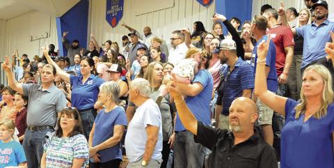 SNOOK BLUEJAY FANS IN attendance at the recent “Meet the Bluejays” showed their school spirit during the playing of the Alma Mater. Tribune photo by Denise Squier