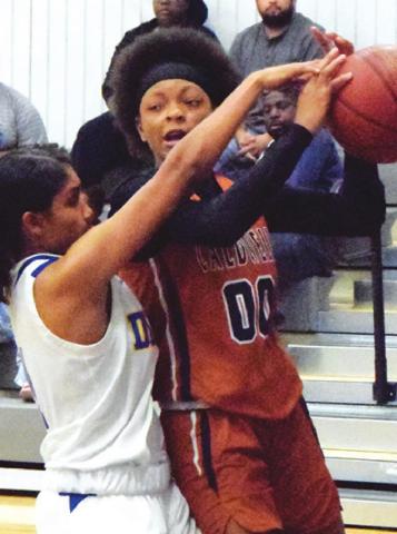 JAE MATHIS IS FOULED while driving the baseline during the Caldwell-Dime Box basketball game last Friday in Dime Box.