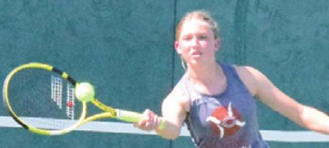 CALDWELL’S TILLY Hicks returns serve during a girls doubles match in Franklin last Thursday. -- Tribune photo by Denise Squier