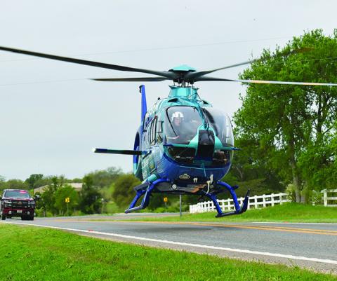 A HELICOPTER TRANSPORTS the driver in a one-vehicle accident early Monday, March 31, on F.M. 60 West near Park Road 4. No details on the accident were available at press time.