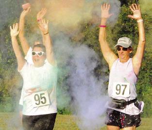 THIS GROUP OF RUNNERS embraced their color shower at this checkpoint during Saturday’s “Debbie’s 5K Color Walk,” benefiting the Pena Brothers Memorial -- which supports local scholarships, local charities and education to prevent alcohol abuse. Tribune photo by Denise Squier