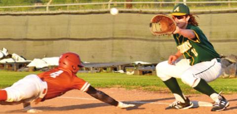 KAIN SANCHEZ DIVES back to first base as the ball is thrown.