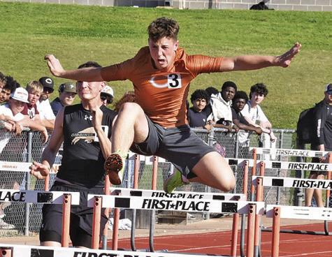CALDWELL’S KRUSH STRANGE leaps over hurdles during last Thursday’s Happy Skrabanek Relays in Caldwell. Tribune photo by Roy Sanders