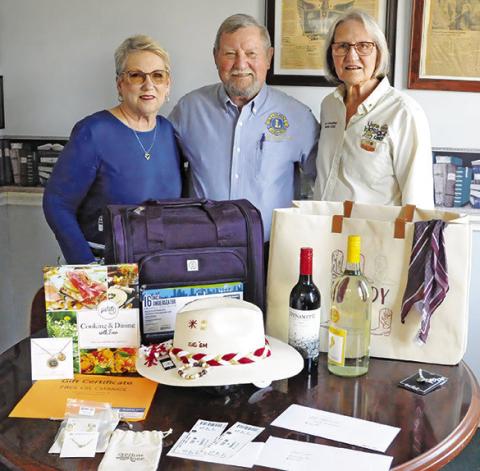 CALDWELL BURLESON COUNTY Lions Club members Kathy Cornett, Adrian Drouilhet and Pat Drouilhet are pictured with some of the silent auction and raffle items. Tribune photo by Denise Squier
