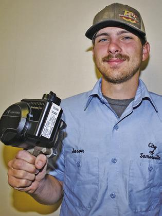 JASON BRAY of the City of Somerville displays this new water meter being installed.