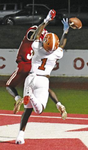 TAVAREAN GRIMES reaches high for this pass against Groesbeck last Friday in Groesbeck. -- Tribune photo by Roy Sanders