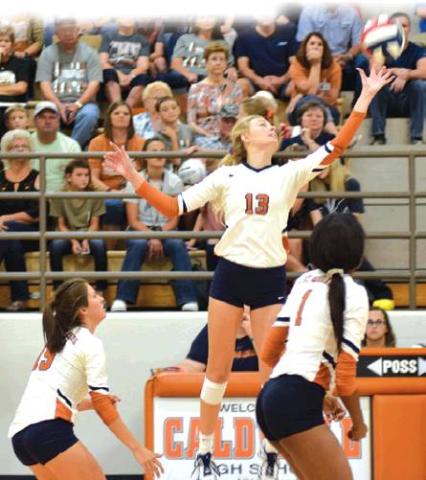 CALDWELL’S MARLEY MAURER pushes the ball over the net during the Lady Hornet’s straight set win over Franklin on Friday night at Hornet Gym. Also pictured are Kaylee Maurer and Aaliyah Massingill. Caldwell also beat Sealy on Tuesday, Aug. 20, and was 4-1 at the Robinson Tournament, with a second place finish, last week to improve to 22-3 for the season and rank Number 5 in Class 4A in the latest Texas Girls Coaches Association Poll. -- Tribune photo by Denise Hornaday