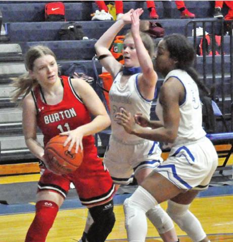 LADY JAY BASKETBALL PLAYERS, Kamree Walker and Jaivan Stringfellow, defend while a Burton player looks for help from a teammate during Snook’s 70-19 win last Friday night at home.
