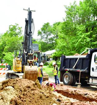 A CONSTRUCTION CREW works on this sewer line replacement project on Friday, May 30, on Hill Street near State Highway 21.