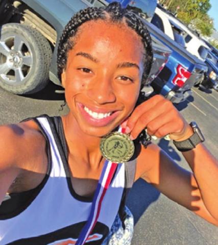 SOMERVILLE CROSS country runner Ra’Maya Carter poses with her medal she earned at last week’s Cameron Invitational.