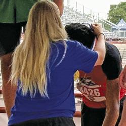 JEREMY VELA is draped with his gold medal by a UIL official at the UIL State Track &amp; Field Meet in Austin last week. Tribune photo by Denise Squier