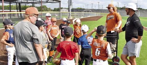 CALDWELL HIGH SCHOOL Head Baseball Coach Luke Calvert, second from the right, addresses these boys on Monday, June 2, at the baseball camp. The camp was well attended.