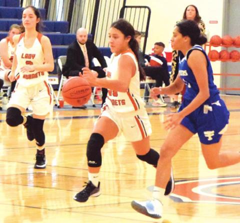 CALDWELL’S ANDREA FLORES drives down the court during the Lady Hornet’s game against Victoria St. Joseph last Tuesday afternoon.