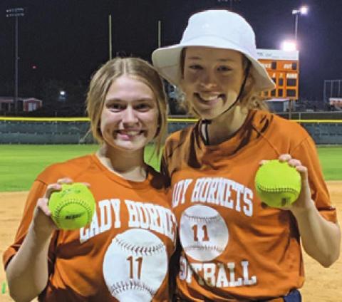 LADY HORNETS, Kelly Urbanovsky, left, and Kyleigh Gomez, right, hit home runs against Bellville in last Monday night’s scrimmage.