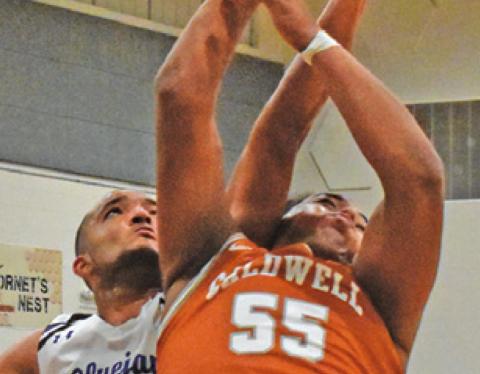 DELVIN MORRIS of Caldwell fights for the ball in the Hornets’ 72-49 victory.