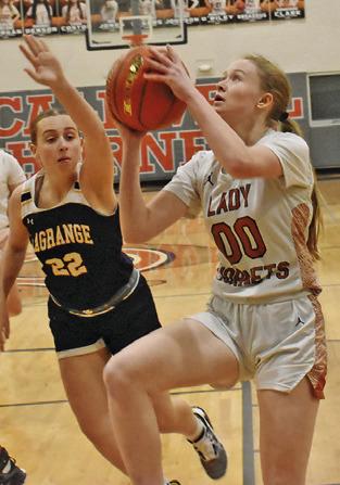 THE LADY HORNETS hosted La Grange last Friday with the Lady Leps winning 63-22. TOP: IRELAND MORGAN eyes the basket while La Grange’s Hannah Gross attempts a block. BOTTOM: AMOREE DENSON dribbles around La Grange’s Victoria Harold.