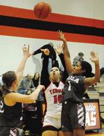 BRYANNA SUROVIK shoots over two Iola defenders during the Somerville-Iola game last week. -- Tribune photo by Denise Squier