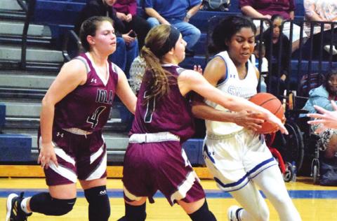 SNOOK’S JAIVAN STRINGFELLOW is fouled while trying to dribble around Iola’s Ava Pointer during the Lady Jay’s 46-27 District 26-2A win over the Iola Lady Bulldogs last Tuesday night. Stringfellow scored seven points for Snook in the victory. -- Tribune photo by Denise Hornaday