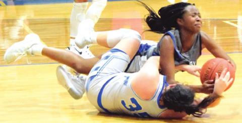 SNOOK’S MACKENZIE GROCE fights for possession of the ball with an Anderson-Shiro player during a tournament game last week.