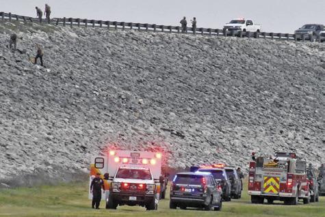 EMERGENCY RESPONDERS WORK the scene of this accident off the Lake Somerville Dam Road on Saturday. Tribune photo by Roy Sanders