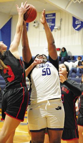 MYKIA MUNSON REACHES for a rebound during the Snook-Richards game last week in Snook.