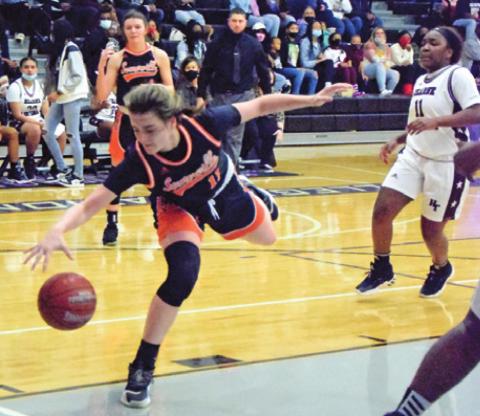 SOMERVILLE’S HALLE STEVENS dives to grab a pass from teammate Ra’Maya Carter during the Lady Yeguas’ area round loss to Hearne last Friday night. -- Tribune photo by Denise Squier