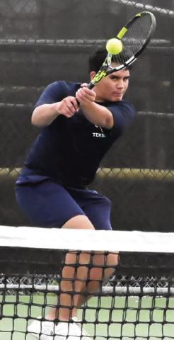 FELIPE GAUCIN eyes his shot during a district match earlier in the team tennis season at the Caldwell High School tennis courts. Tribune photo by Denise Squier