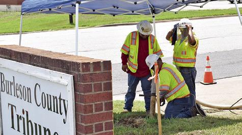 A CREW FROM LARRETT Energy Services of Venus works at the Burleson County Tribune off State Highway 21 West and Thomas Street in preparation for Atmos work beginning next week.