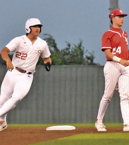 CALDWELL’S CASON RUSS runs to second base against Bellville. Tribune photo by Roy Sanders