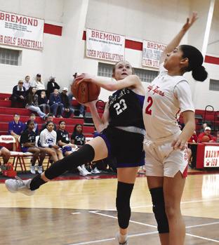 SNOOK’S DAKOTA KIENOW tries to shoot and avoid a foul during the Lady Jays’ away game in Bremond on Friday night. Tribune photo by Roy Sanders
