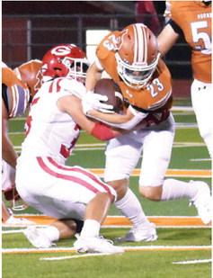 BRANDON FRITCHER of Caldwell carries the ball against Groesbeck in the season opener. Tribune photo by Roy Sanders