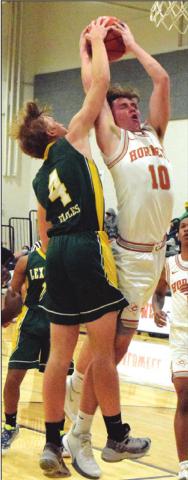 RYAN ROEHLING is fouled by Lexington’s Ty Hawley while trying to score last Tuesday night. -- Tribune photo by Denise Squier