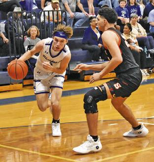 BRETT WITHEM of Snook dribbles past Somerville’s Gavin Williams. Tribune photo by Roy Sanders
