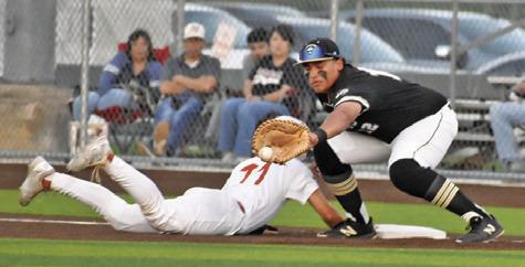 HAYS BEAVERS OF Caldwell slides back into first base. Tribune photo by Roy Sanders