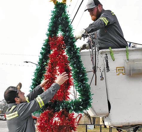 CITY OF CALDWELL employees take down the Christmas decorations on Monday, Jan. 5, in downtown Caldwell. Tribune photo by Roy Sanders