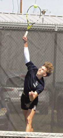 CALDWELL’S DYLAN Chapman serves at the Caldwell Classic Varsity Tennis Tournament. Tribune photo by Denise Squier