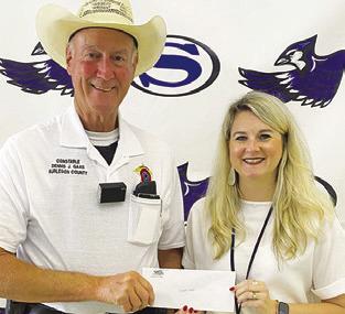 COPS4KIDS RECENTLY donated $2,050 to Snook ISD. The check was presented to new Superintendent Kimberly Giesenschlag by Constable Dennis J. Gaas.